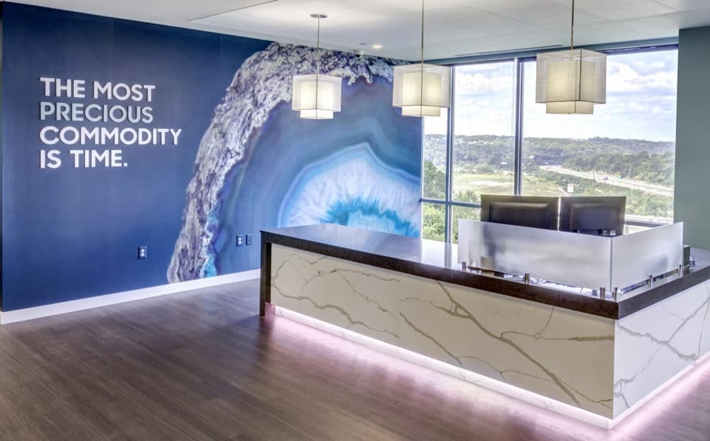 office lobby featuring a quote about time being precious
