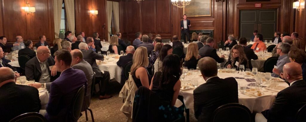 Andrew giving a speech at a dinner event