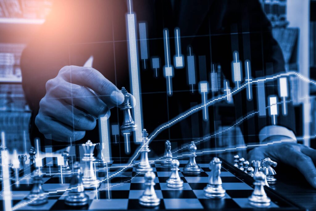 man playing chess with the stock market overlaid